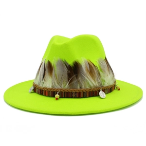 Detail of neon green fedora hat featuring real feathers, ethnic bands and coin pendants