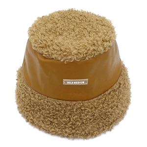 Détail du patchwork en polaire kaki et cuir marron sur le chapeau bob d'hiver chaud