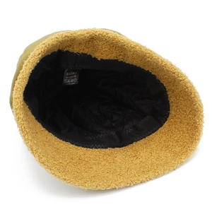 Detail view of cotton octagonal hat with yellow fleece exterior and quilted black lining