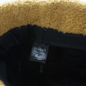 Detail of Mokati teddy fleece octagonal hat showing 100% cotton lining and inner label