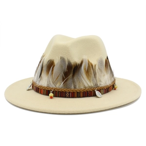 Detail of beige fedora hat featuring ethnic woven band, natural feathers and metal coins