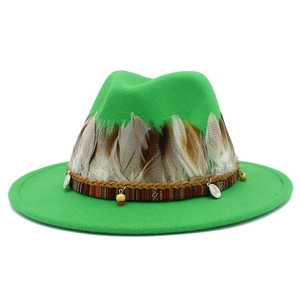 Detailed view of green wool felt fedora with feather trim and ethnic braided band