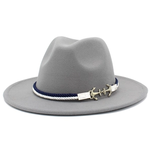Detail of grey wool fedora featuring a blue-white braided band and golden anchor buckle