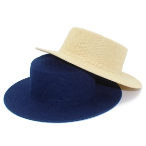 Close-up of finely woven dark blue and beige boater hats with flat tops and wide brims