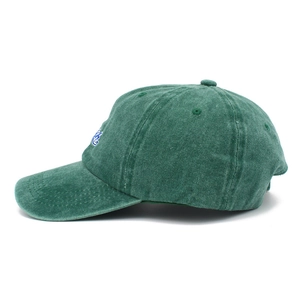 Detail shot of vintage dark green cotton baseball cap with side embroidery and washed texture