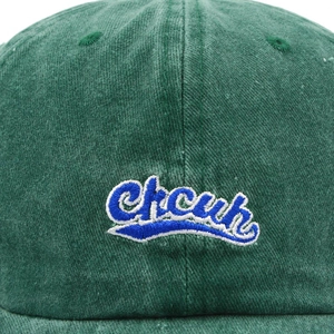Front view of dark green washed cotton baseball cap with blue embroidered logo on white background