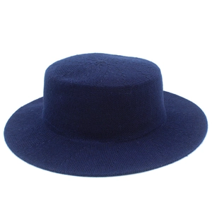 Elegant navy blue knit boater hat with flat top and wide brim for women on white background