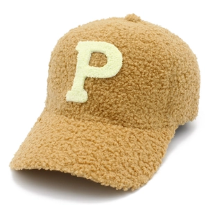 Detail of soft brown faux sheepskin fabric and white embroidered P letter on baseball cap