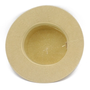 Detail view of woven straw sun hat interior showing sweatband and fine fiber texture
