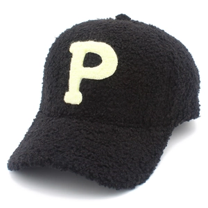 Detailed macro view of black faux shearling texture with yellow towel embroidery letter P
