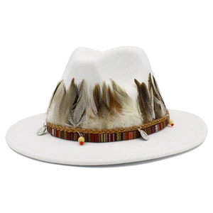 Detail of white fedora with exotic feathers, leather braid and ethnic coin charms