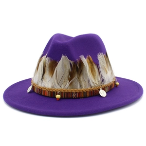 Close-up of purple wool fedora featuring ethnic woven band, beads and natural feathers