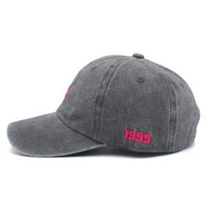 Detail shot of vintage washed cotton baseball cap with pink 1999 embroidery on side