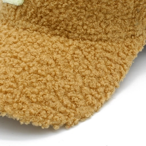 Close-up of the soft curly texture on this warm brown faux lamb wool baseball cap