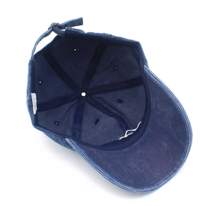 Detailed interior of navy cotton baseball cap with adjustable metal buckle and wash label