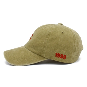Detail view of vintage cotton baseball cap featuring red 1999 embroidery and washed texture