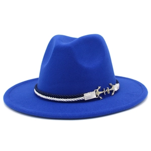 Detail of royal blue wool fedora featuring nautical braided band and gold anchor buckles