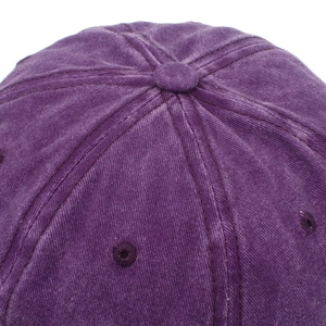 Close-up of purple washed cotton baseball cap crown with stitched eyelets and top button
