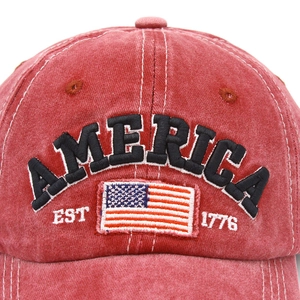 Close-up of vintage washed red baseball cap with America flag patch and detailed embroidery