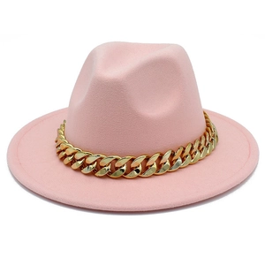 Close-up of pink fedora hat with a thick gold chain decoration on high quality felt