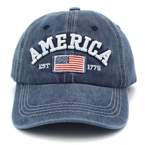 Close-up of white 3D embroidery with America text and flag on blue washed cotton cap