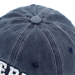 Close-up of cotton baseball cap crown with contrast stitching and embroidery details
