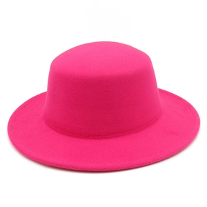Detailed view of vibrant magenta wool felt flat top boater hat with clean stitching
