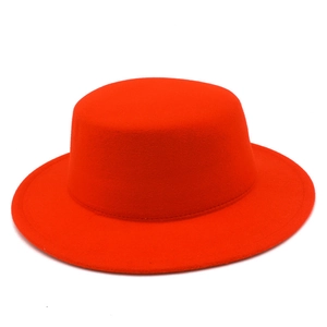 Top-down view of a classic red wool felt flat-top jazz hat with a straight wide brim