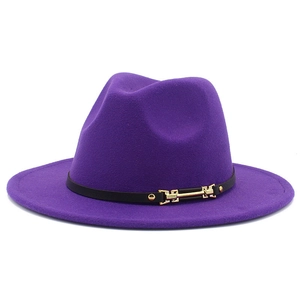 Detail of purple flat brim fedora hat featuring black band with gold metal buckle