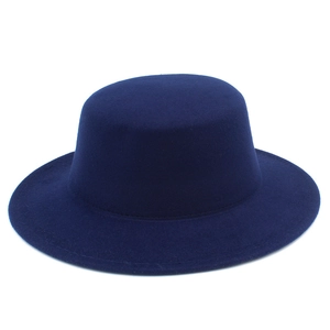 Detailed view of a dark blue flat top wool felt hat with a smooth texture and wide brim