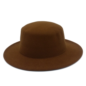 Close-up of flat top wool felt hat in dark brown featuring detailed stitching on the crown