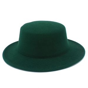 Close-up of the fine texture and stitch detail on a dark green wool felt boater hat