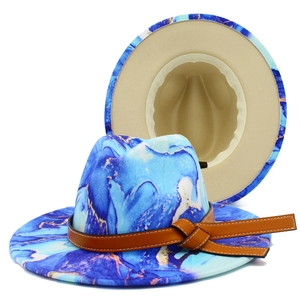 Detailed view of tie-dye fedora hat with blue marble pattern and brown leather band