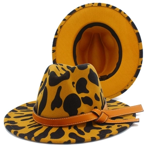 Cowboy fedora hat with leopard print and decorative leather band on a white background
