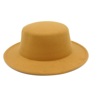 Detailed texture of mustard yellow wool felt boater hat with flat top and wide stiff brim