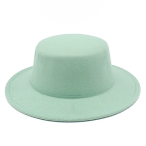 Detailed close-up showing the flat top structure and mint green wool felt of the hat
