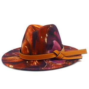 Elegant wide brim fedora hat featuring tie-dye marble pattern and brown leather band