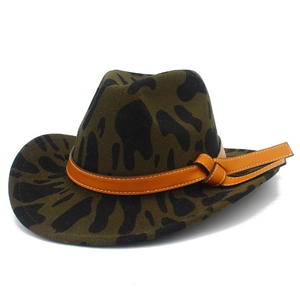 Close-up of olive green felt cowboy hat with black cow print and orange leather band