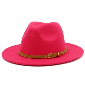 Detail of a rose red wool fedora with a brown leather belt and golden metal buckle
