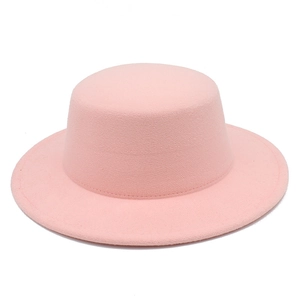 Close-up of pink wool felt boater hat with flat top and wide brim showing fine stitching