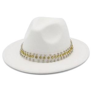 Detailed view of white fedora hat with elegant silver studs and champagne square crystals