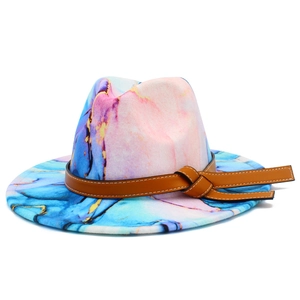 Detail of a wide brim fedora featuring a colorful tie-dye marble pattern and leather band