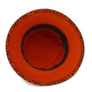 Detail of orange wool fedora showing leopard print brim and adjustable inner sweatband