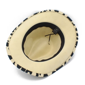 Detail view of cow print fedora interior with beige lining and adjustable sweatband