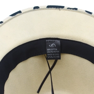 Detail view of cotton polyester wool hat inner label showing materials and sweatband