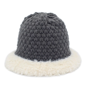 Detail view of winter knit bucket hat with dark grey wool and cream plush faux fur trim