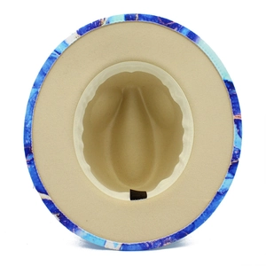 Detail view of cotton fedora hat interior with blue marble pattern on the wide brim
