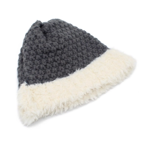 Detail of grey chunky knit beanie with thick white faux fur trim on a white background
