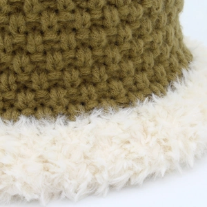 Close-up of retro knit bucket hat featuring dark green yarn and white plush fur trim