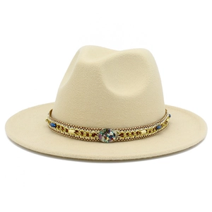 Detail of bohemian fedora hat featuring woven band with blue beads and stone buckle